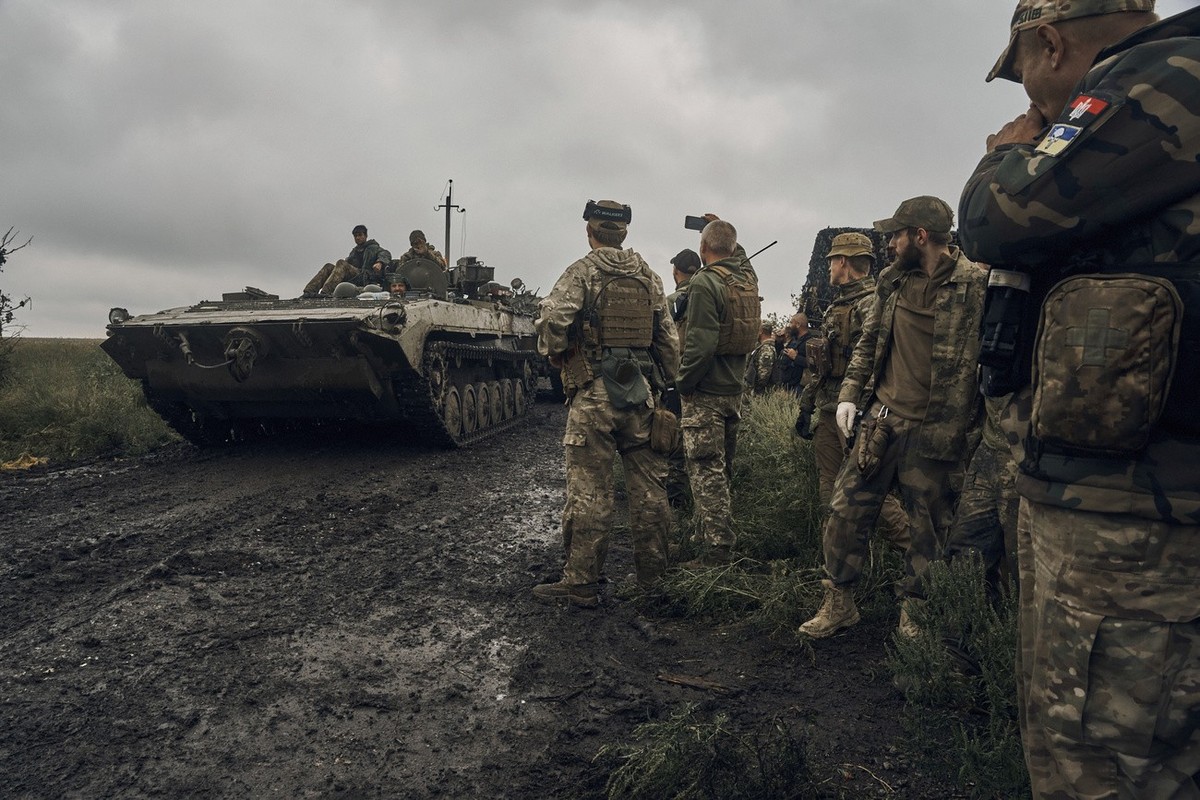 Ukrainian military vehicles move on the road in the freed territory in the Kharkiv region, Ukraine, Monday, Sept. 12, 2022. Ukrainian troops retook a wide swath of territory from Russia on Monday, pus ...