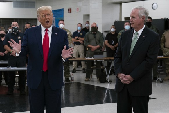 FILE - In this Sept. 1, 2020 file photo, President Donald Trump speaks in Kenosha, Wis., as Sen. Ron Johnson, R-Wis., right, listens. Sen. Johnson said Monday, Sept. 14, 2020, that President Donald Tr ...