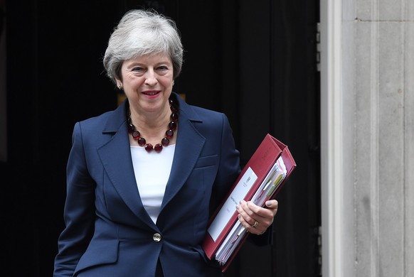 epa07099494 British Prime Minister Theresa May departs Downing Street for Prime Minister questions at parliament in London, Britain, 17 October 2018. May is set to meet EU leaders later today in Bruss ...