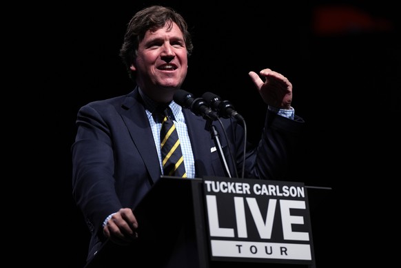 Tucker Carlson speaks before talking with Republican presidential nominee former President Donald Trump at a Tucker Carlson Live Tour show at Desert Diamond Arena, Thursday, Oct. 31, 2024, in Glendale ...