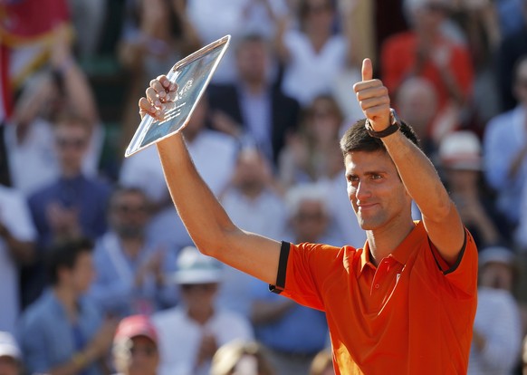 Novak Djokovic of Serbia poses with the trophy during the ceremony after being defeated by his Stan Wawrinka of Switzerland during their men&#039;s final match at the French Open tennis tournament at  ...
