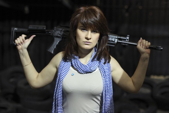 FILE - In this Sunday, April 22, 2012 filer, Maria Butina, a gun-rights activist, poses for a photo at a shooting range in Moscow, Russia. Accused of working as an undeclared foreign agent in the U.S. ...