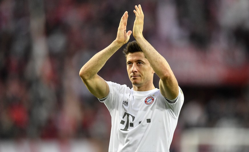Bayern's Robert Lewandowski celebrates with supporters after winning the German Bundesliga soccer match between 1. FC Cologne and Bayern Munich in Cologne, Germany, Sunday, Feb. 16, 2020. (AP Pho ...