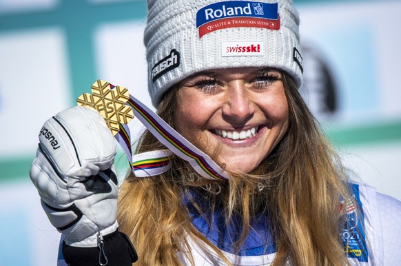 Corinne Suter of Switzerland celebrates with the Gold medal for Downhill race during the medals ceremony after the women&#039;s Downhill race at the 2021 FIS Alpine Skiing World Championships in Corti ...