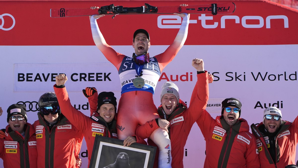 First place finisher Switzerland's Thomas Tumler, top, celebrates with teammates and coaches after a men's World Cup giant slalom skiing race, Sunday, Dec. 8, 2024, in Beaver Creek. (AP Phot ...