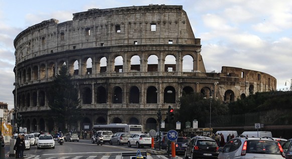 Brazilian Formula E Development Driver Lucas Di Grassi, center, foreground, steers his Formula E car amidst private traffic past the ancient Colosseum in Rome, Saturday, Dec. 1, 2012 to promote the ne ...