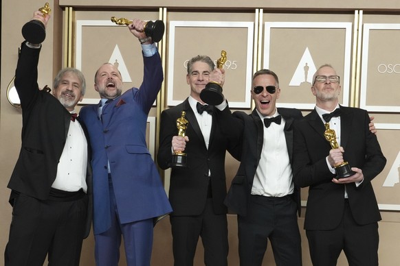 Mark Weingarten, from left, James H. Mather, Al Nelson, Chris Burdon and Mark Taylor, winners of the best sound award for "Top Gun: Maverick," posing in the press room at the Oscars on Su...