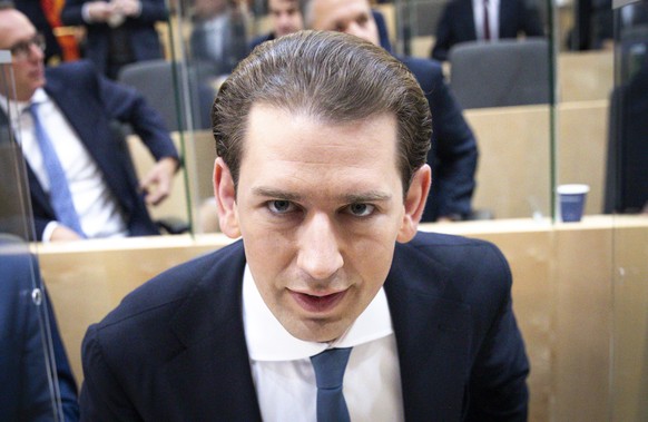 Sebastian Kurz, the former Austrian Chancellor, takes his seat before the sworn-in as deputy in the Austrian Parliament in Vienna, Austria, Thursday, Oct. 14, 2021. (AP Photo/Lisa Leutner)