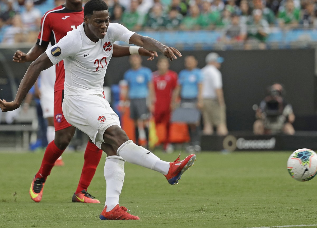 Canada's Jonathan David (20) kicks the ball past Cuba's Daniel Morejon (5) for a goal during the second half of a CONCACAF Golf Cup soccer match in Charlotte, N.C., Sunday, June 23, 2019. (A ...