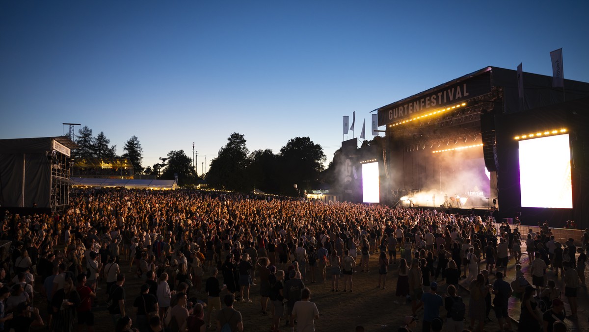 Festival goers cheer the concert of the French band "Phoenix" on the main stage, at the 40th Gurtenfestival edition, in Bern, Switzerland, on Friday, July 14, 2023. The open air music festiv ...