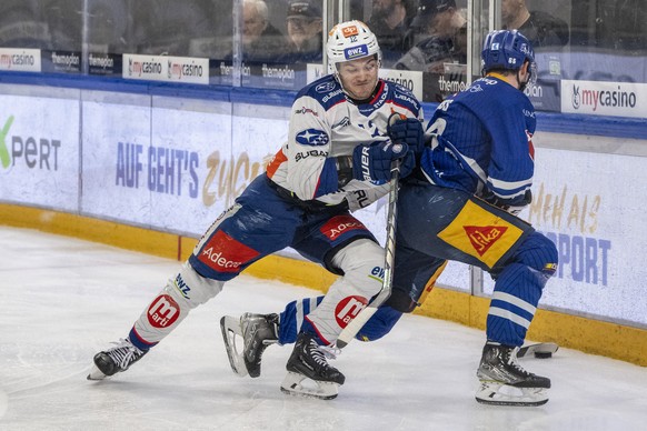 Yannick Zehnder, links, vom ZSC im Spiel gegen Nico Gross, rechts, von Zug beim Eishockey Meisterschaftsspiel der National League zwischen dem EV Zug und den ZSC Lions am Donnerstag, 29. Februar 2024  ...