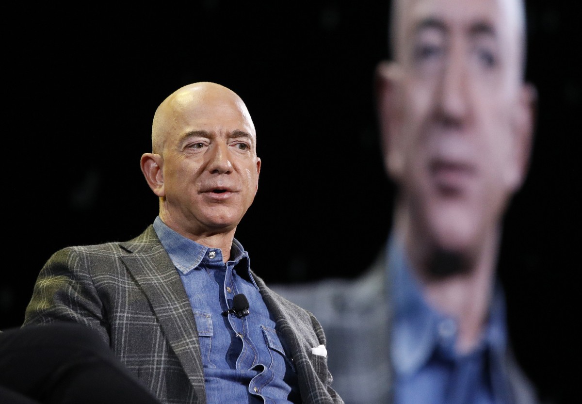 FILE - Amazon CEO Jeff Bezos speaks at the Amazon re:MARS convention in Las Vegas on June 6, 2019. Most news organizations hold its journalists to strict ethical standards to avoid conflicts of intere ...