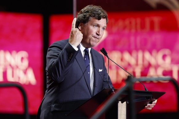 epa12397015 US media personality Tucker Carlson speaks during the public memorial service of political activist Charlie Kirk at State Farm Stadium in Glendale, Arizona, USA, 21 September 2025. Kirk wa ...