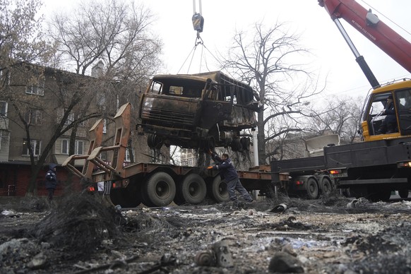 A crane loads a military truck, which was burned during clashes onto the platform in Almaty, Kazakhstan, Sunday, Jan. 9, 2022. Kazakhstan&#039;s health ministry says at least 164 people have been kill ...