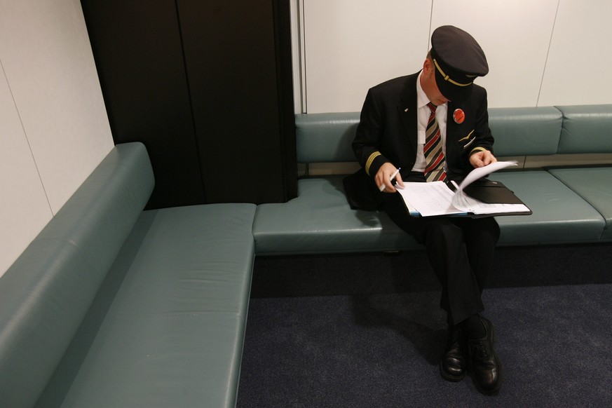 ARCHIV - Ein Pilot der Swiss International Airlines sitzt am Dienstag, 26. September 2006, nach der Vollversammlung der Gewerkschaft Swisspilots auf dem Flughafen Zuerich Kloten auf einer Bank. Die Sw ...