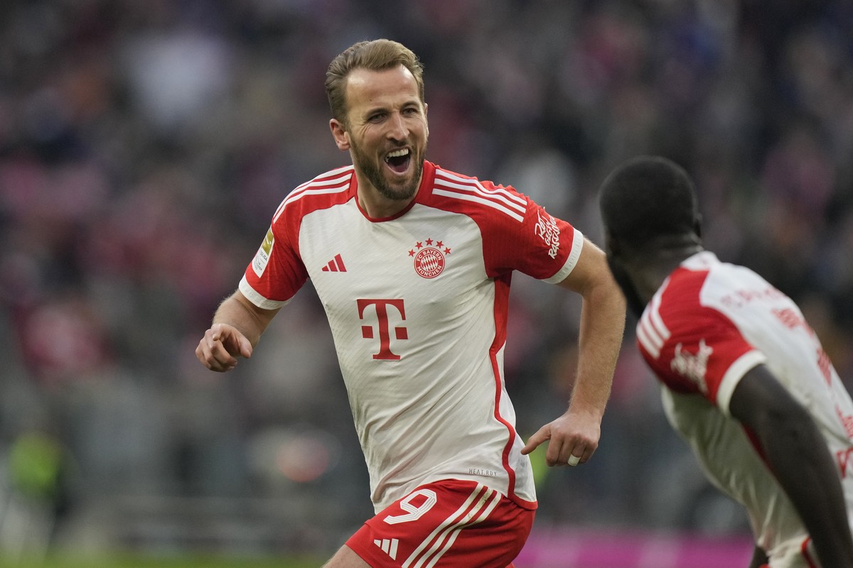 Bayern's Harry Kane, left, celebrates with his teammate Serge Gnabry after scoring his side's second goal during the German Bundesliga soccer match between Bayern Munich and Heidenheim at th ...