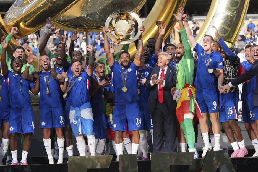 President Donald Trump, sixth from right, watches as Chelsea&#039;s Reece James (24) lifts the trophy following the Club World Cup final soccer match between Chelsea and PSG at MetLife Stadium in East ...