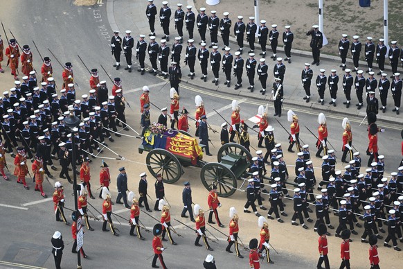 In this photo issued by UK Parliament, the State Gun Carriage carrying the coffin of Queen Elizabeth II, draped in the Royal Standard with the Imperial State Crown and the Sovereign&#039;s orb and sce ...