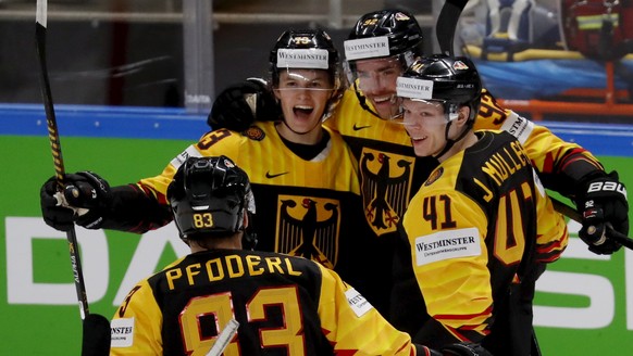 epa09241700 Players of Germany celebrate a goal during the IIHF 2021 World Ice Hockey Championships group B match between Germany and Latvia at the Arena Riga, Latvia, 01 June 2021. EPA/TOMS KALNINS
