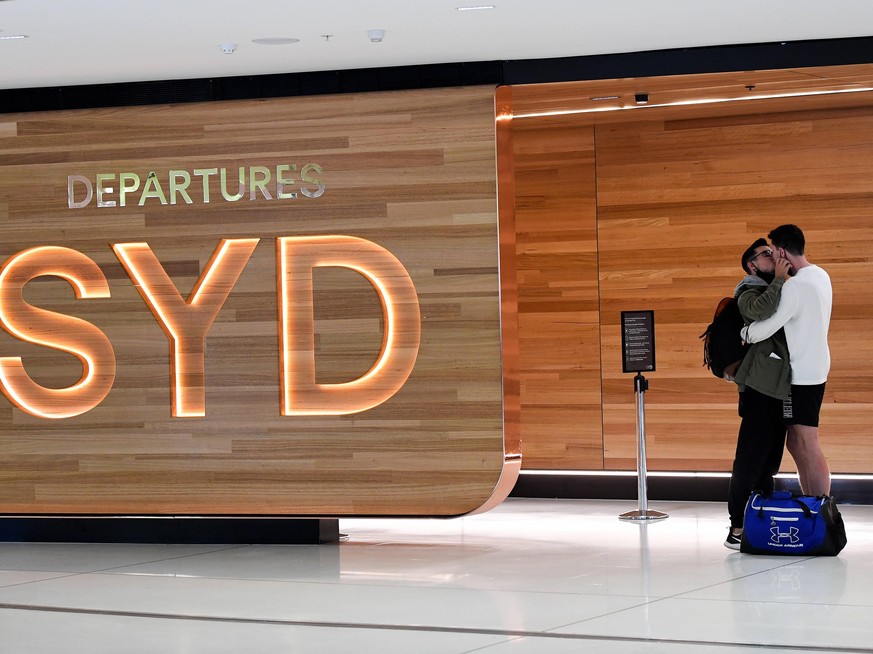 QUARANTINE FREE INTERNATIONAL ARRIVALS SYDNEY, A couple kisses goodbye as travellers depart on the first travel exemption free international flights at Sydney International Airport, Monday, November 1 ...