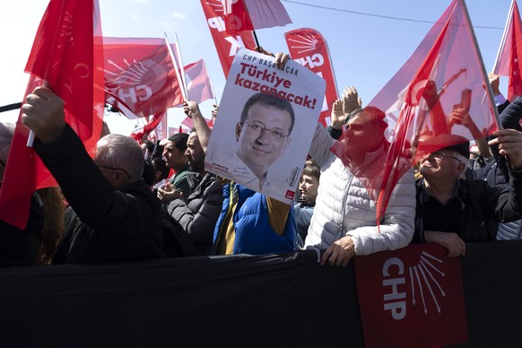 epa11996862 A protester holds a placard depicting Istanbul Mayor Ekrem Imamoglu during a demonstration organized by the main opposition Republican People&#039;s Party (CHP) against his detention, in I ...