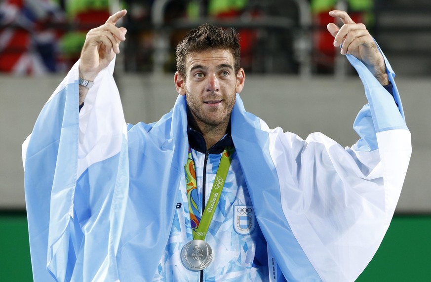 epa05485730 Silver medal winner Juan Martin del Potro of Argentina celebrates after the awarding ceremony of men's singles gold medal match of the Rio 2016 Olympic Games Tennis events at the Olympic T ...