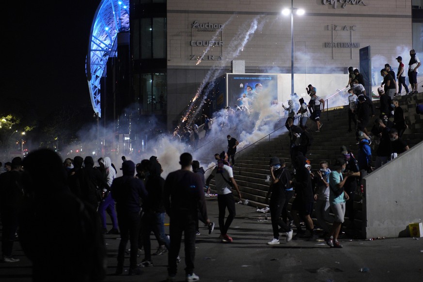 Teargas is thrown at Marseille supporters after the Europa League group E soccer match between Marseille and Galatasaray outside the Stade Velodrome stadium in Marseille, France, Friday, Oct. 1, 2021. ...