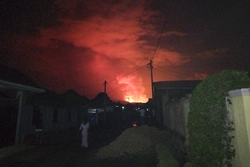 epa09223145 A general view from a neighbourhood in Rwanda of Mount Nyiragongo volcano as it erupted over Goma, Rubavu District, Rwanda, 23 May 2021. One of the planets most active volcanoes Mount Nyir ...