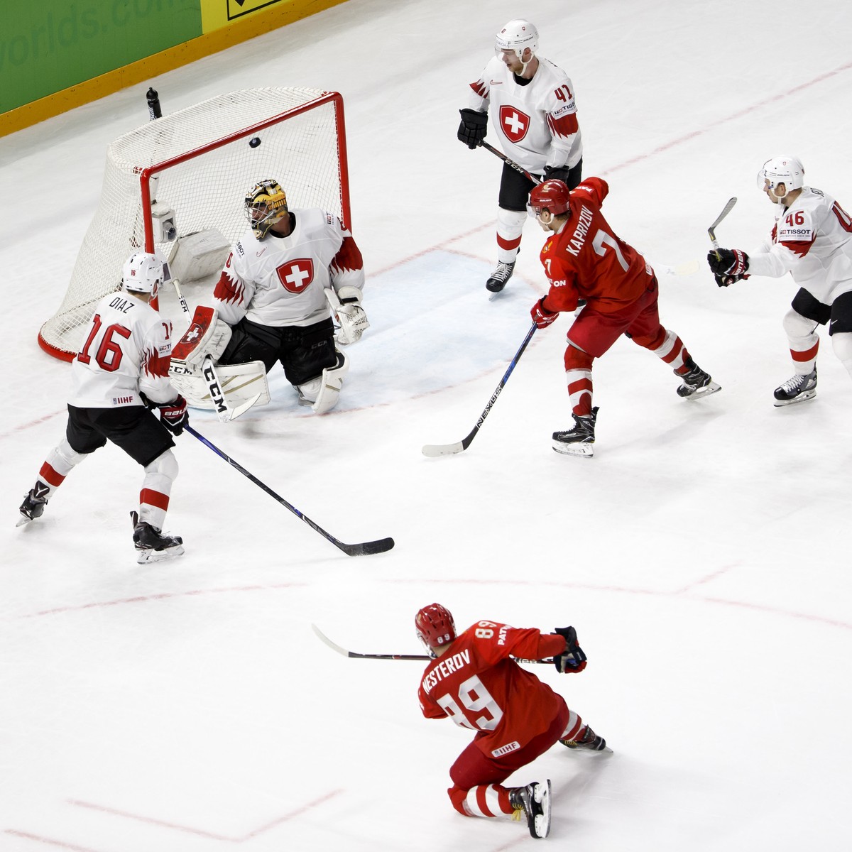 Russia's defender Nikita Nesterov #89 scores the 3:1 against Switzerland's goaltender Reto Berra, 3rd left, past Russia's forward Nikita Gusev, left, Switzerland's defender Raphael ...
