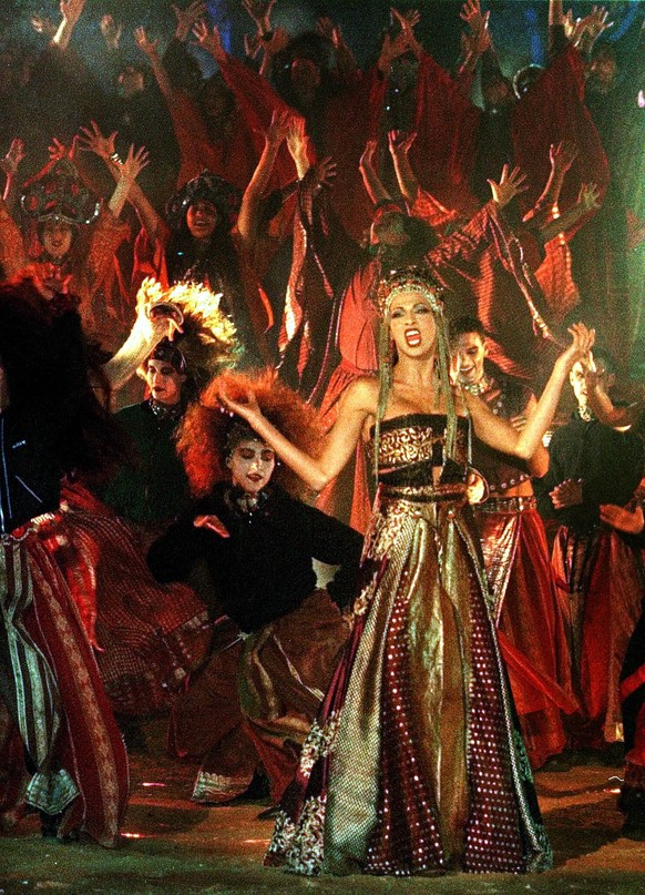 Dana International, winner of the 1998 Eurovision song contest, performs in Jerusalem's Old City streets Tuesday May 11 1999, during the recording of a video clip to be shown in the 1999 Eurovisi ...