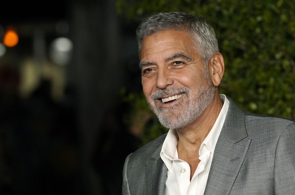 FILE - George Clooney, a cast member in &quot;Ticket to Paradise,&quot; poses at the premiere of the film, Monday, Oct. 17, 2022, at the Regency Village Theatre in Los Angeles. Just weeks after headli ...