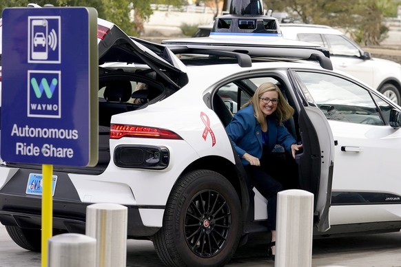FILE - Phoenix Mayor Kate Gallego arrives in a Waymo self-driving vehicle on Dec. 16, 2022, at the Sky Harbor International Airport Sky Train facility in Phoenix. Self-driving car pioneer Waymo announ ...