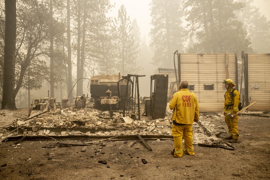 epaselect epa08665588 Berry Creek volunteer fire chief Reed Rankin (L), who lost his home in the fire, surveys the Station 61, where he has worked at for over 25 years, after it was destroyed by the B ...