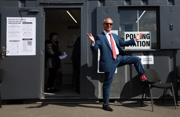 epa12938401 Reform UK leader Nigel Farage shows off his Union flag socks after voting in local elections in Clacton-on-Sea, Britain, 07 May 2026. Millions of Britons are voting across the country in l ...