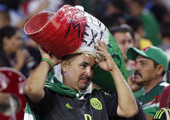 A disappointed Mexico fan adjusts his sombrero after a CONCACAF Gold Cup soccer match against Guatemala Sunday, July 12, 2015, in Glendale, Ariz. The game ended in a 0-0 tie. (AP Photo/Ross D. Frankli ...