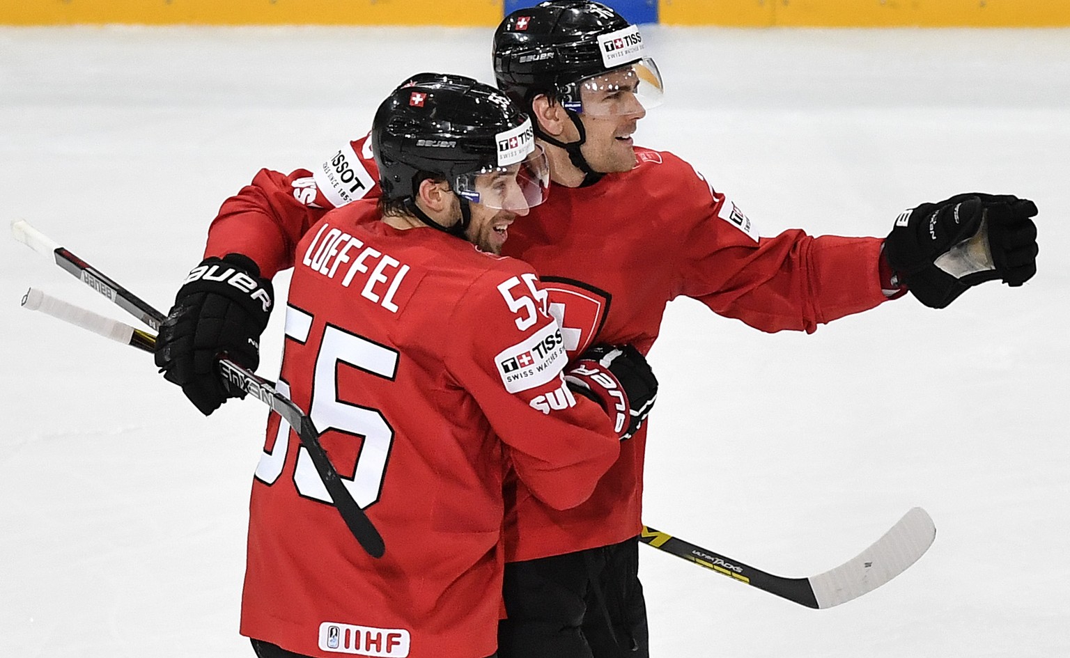 Switzerland’s Romain Loeffel, left, and Joale Genazzi celebrate their second goal during their Ice Hockey World Championship group B preliminary round match between Switzerland and Finland in Paris, F ...