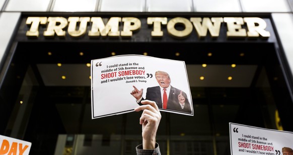 epa05215085 A group of gun control advocates from the Brady Campaign to Prevent Gun Violence hold a small protest against Republican presidential candidate Donald Trump in front of Trump Tower in New  ...