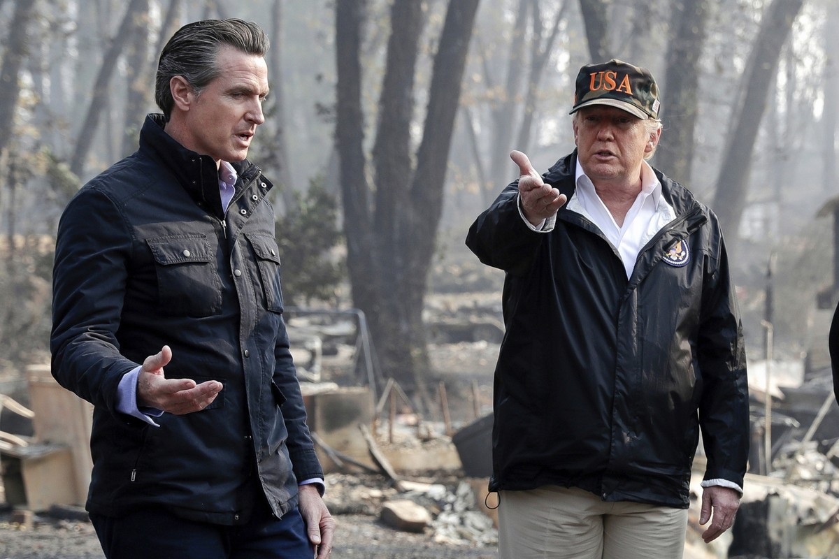 FILE - President Donald Trump talks with then California Gov.-elect Gavin Newsom, left, during a visit to a neighborhood impacted by the wildfires in Paradise, Calif., Nov. 17, 2018. (AP Photo/Evan Vu ...