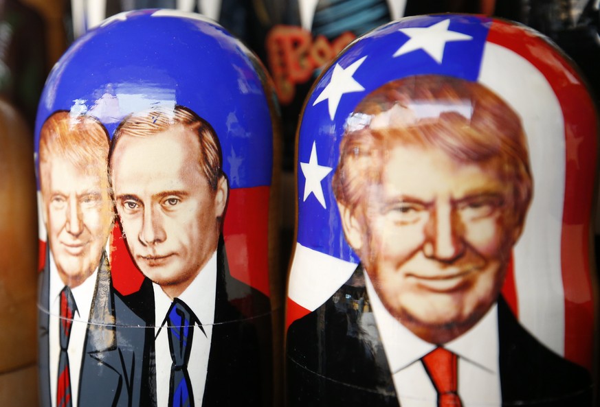 epa05992746 Traditional Russian Matryoshka wooden dolls also known as nesting dolls, illustrated with the images of US President Donald J. Trump and Russian President Vladimir Putin, on a display at a ...