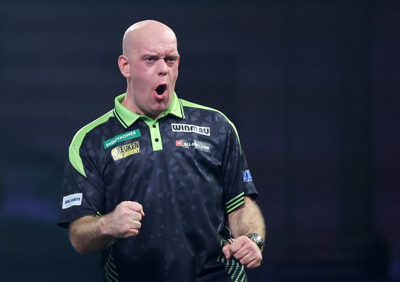 epa12610402 Michael van Gerwen of the Netherlands gestures as he plays against Irelands William O'Connor during their second round World Darts Championships match at Alexandra Palace in London,  ...