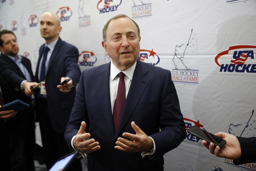 FILE - NHL Commissioner Gary Bettman speaks with members of the media before being inducted into the U.S. Hockey Hall of Fame in Washington, in this Thursday, Dec. 12, 2019, file photo. Like the NBA,  ...