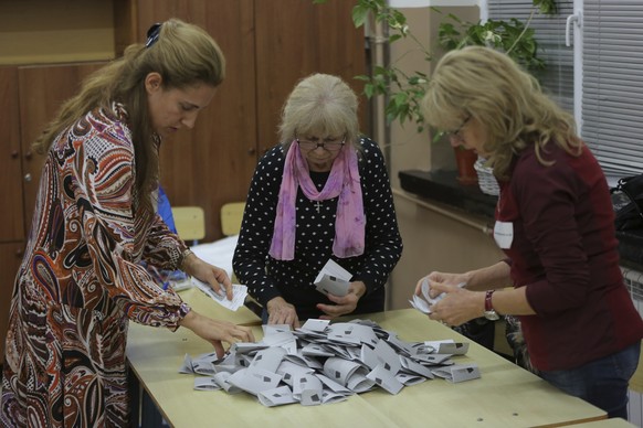 Election officials count the casted ballots in general election after the polling station closed in Sofia, Bulgaria, Sunday, Oct. 2, 2022. Bulgarians voted for the fourth time in less than two years i ...
