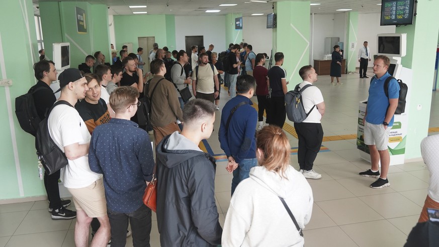 Russians lineup to get Kazakhstan's a Personal Identification Number (INN) in a public service center in Almaty, Kazakhstan, Tuesday, Sept. 27, 2022. A day after President Vladimir Putin ordered a par ...