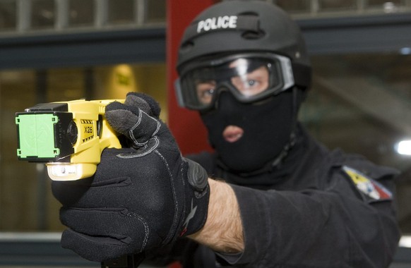 A member of Geneva&#039;s Intervention Group Police demonstrates a Taser X26 electroshock weapon at the Geneva Police headquarters in Geneva, Switzerland, Monday, April 27, 2009. A Taser is an electro ...
