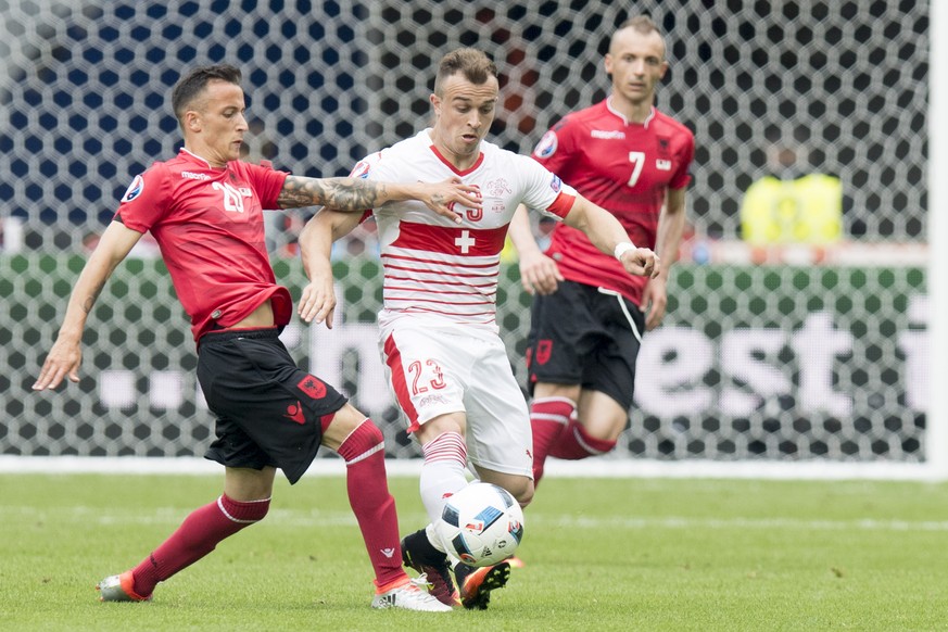 Albania&#039;s midfielder Ergys Kace, left, fights for the ball with Swiss forward Xherdan Shaqiri, center, in front of Albania&#039;s defender Ansi Agolli, right, during the UEFA EURO 2016 group A pr ...