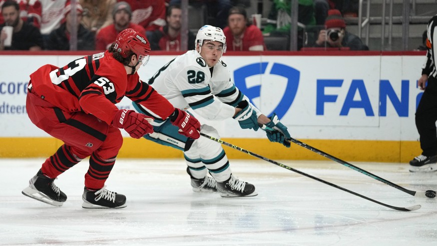 Detroit Red Wings defenseman Moritz Seider (53) defends San Jose Sharks right wing Timo Meier (28) in the third period of an NHL hockey game Tuesday, Jan. 24, 2023, in Detroit. (AP Photo/Paul Sancya)