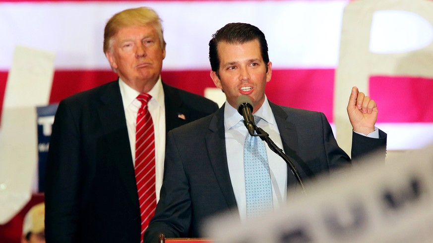 epa06082457 (FILE) - US Republican Presidential candidate Donald J. Trump (L) listens to his his son Donald Trump Jr. speaking to supporters during a rally at Lakefront Airport in New Orleans, Louisia ...