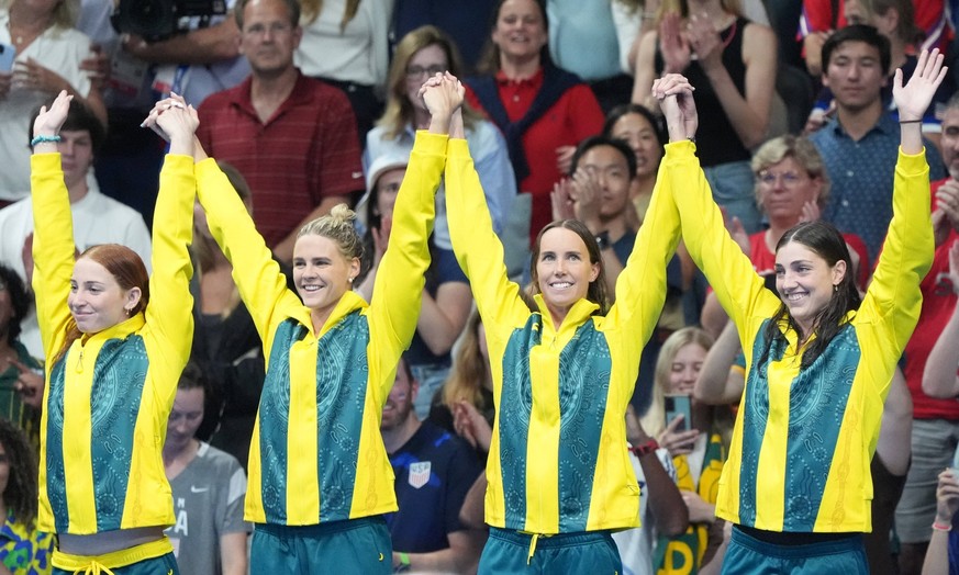 The Australian women s 4x100-meter freestyle relay team celebrates on the podium after winning the gold medal at the 2024 Summer Olympics, in Paris, France, on Saturday, July 27, 2024. PUBLICATIONxINx ...