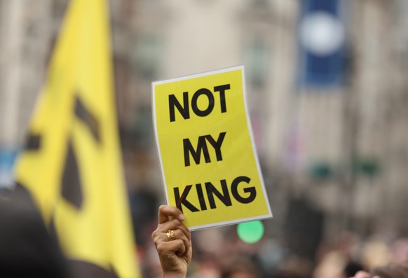 epa10611453 A person raises a placard as anti-monarchy group Republic protest on the day of the Coronation of Britain&#039;s King Charles III in London, Britain, 06 May 2023. The group wants to see th ...