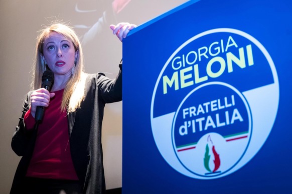 epa06539392 Right-wing party Brothers of Italy (Fratelli d&#039;Italia) leader Giorgia Meloni in front of an electoral logo during a meeting with her supporters in Rome, Italy, 18 February 2018. The I ...